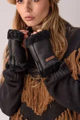 Guantes sin dedos de cuero color suela con interior de piel sintética y detalles de tachas metálicas. Incluye etiqueta de marca Bona.