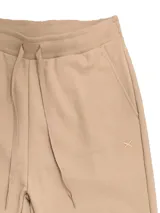 Pantalón babucha deportivo unisex azul, de tiro alto, con puños y cordones ajustables.