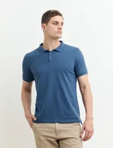 Remera polo azul oscuro con cuello y puños acanalados, y logo bordado en el pecho.