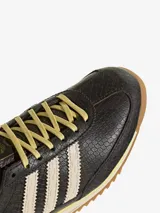 Championes Adidas SL 72 OG modelo para mujer, con diseño de perfil bajo y capellada de cuero con textura efecto piel de serpiente en color marrón oscuro. Presenta las tres tiras laterales en tono blanco, cordones amarillos claros y suela dentada de goma.