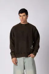 Buzo de cuello redondo con efecto desgastado, de calce oversize y mangas largas. Presenta un pequeño logo estampado en la parte inferior frontal y una etiqueta pequeña en el puño.