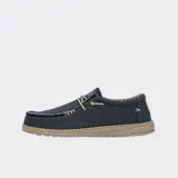 Zapatos Hey Dude modelo Wally Braided, confeccionados en tejido textil color marrón con cordones elásticos beige, costuras visibles en el empeine y suela ligera de goma.