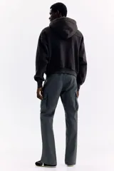 Pantalón cargo gris oscuro de nylon con corte estándar, cintura elástica con cordón ajustable, bolsillos con cierre en los laterales y bolsillos de parche con solapa en las piernas.