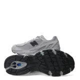 Championes urbanos New Balance modelo 509, color gris, confeccionados en una combinación de malla y gamuza. Presentan el logo 'N' en color negro en los laterales y suela con tecnología ABZORB para mayor amortiguación.