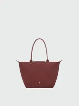 Bolso tote grande Le Pliage One de Longchamp, color negro, con asas superiores y solapa de cierre con botón a presión.