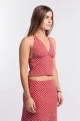 Top con estampado geométrico rojo y blanco, escote halter y espalda descubierta.