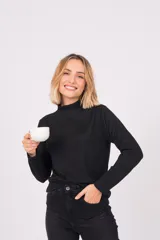 Polera de lanilla color champagne, de cuello alto y manga larga.