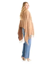 Ruana tejida con estampado de arabescos en tonos beige, con cuello y bordes frontales decorados con aplique de piel sintética y terminación con flecos en el ruedo.