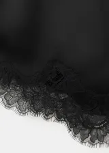 Top de satén negro con tirantes finos, escote en V y detalles de puntilla en el escote y el dobladillo inferior.
