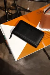 Billetera de cuero color rosa con cierre perimetral. Se abre completamente como un libro, con múltiples espacios para tarjetas, billetes y monedero con cierre incorporado.