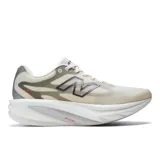 Championes de running New Balance SuperComp Rebel V1, color blanco marfil con detalles en gris y negro, logo "N" en el lateral y entresuela amortiguada con tecnología Energy Arc e Infinion Foam.