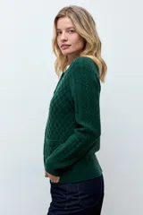 Cardigan de punto color verde oscuro con diseño de textura de rombos, cuello redondo y cierre frontal con botones a tono.