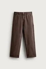 Pantalón jeans relaxed fit de color marrón con efecto lavado, de corte recto y estilo carpintero. Cuenta con bolsillos laterales, bolsillos traseros, bolsillos aplicados y tira multifunción en la pierna. Cierre frontal con cremallera y botón metálico.
