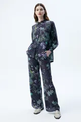 Pantalón palazzo de tencel color negro con estampado de diseño orgánico, tiro alto y pierna ancha.