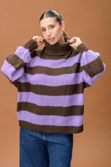Sweater de punto grueso con cuello alto tipo polera, diseño a rayas horizontales en colores marrón y lila, de calce relajado y mangas amplias.