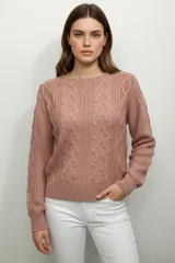 Sweater de tejido punto trenzado, color rosado, con cuello redondo y manga larga.