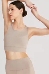 Top deportivo negro de cintura ancha, realizado en tela doble suave y de alta elasticidad. Detalle de breteles cruzados en la espalda.