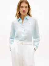 Camisa Tommy Hilfiger de corte amplio confeccionada en lino puro de color celeste, con cuello inglés, manga larga con puños abotonados y detalle del logo bordado en el pecho.