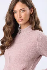 Campera tejida de punto con cierre frontal completo, cuello tipo mao y puños acanalados. Presenta un parche decorativo de cuero sintético en la parte inferior y un diseño de textura suave y abrigada.