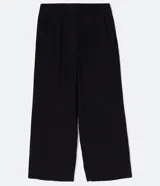 Pantalón negro de vestir, tiro alto, corte wide leg (pierna ancha), con bolsillos laterales y cierre frontal con cremallera y gancho.