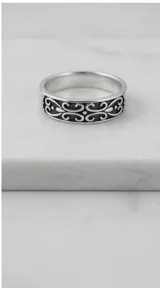 Anillo de banda ancha fabricado en plata 925, con diseño labrado de filigrana en relieve con acabado oxidado.