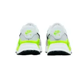 Championes Nike Air Max Systm de diseño deportivo, color blanco con detalles en gris claro, negro y verde neón. Presentan el logo de la marca en negro en el lateral y una unidad de aire visible en el talón con marco verde neón.