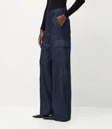 Pantalón wide leg de jean azul oscuro, con cintura media, bolsillos cargo laterales con solapa y cierre frontal con botón y cremallera.