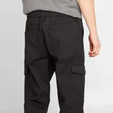 Pantalón jogger negro con bolsillos cargo con solapa, corte slim y puños elásticos.