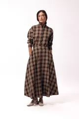 Falda larga de corte evasé con estampado de cuadros en tonos tierra, presenta cintura definida y bolsillos laterales.