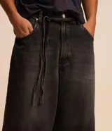Bermuda de jean para hombre, modelo super baggy, con lavado dirty y cinturón de lazo en la cintura.