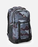 Mochila Rip Curl modelo Dawn Patrol 30L Search, de diseño estampado tipo camuflado en tonos gris, azul y negro. Cuenta con compartimento principal tipo rollo, bolsillos frontales con cierre, bolsillo lateral de malla para botella, correas ajustables y base negra reforzada.