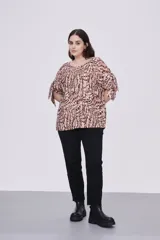 Blusa estampada con cuello redondo y mangas cortas con aberturas y lazos.