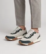 Championes estilo jogging Viko para hombre, confeccionados en material sintético con recortes en verde oscuro y base en tono crudo. Presentan cordones de ajuste y suela de goma con relieve.