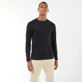 Camiseta térmica de manga larga con cuello redondo y costuras raglán, diseñada para ofrecer ajuste y calidez.