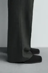 Bota corta color marrón de piel con acabado serraje, cierre de cremallera lateral, horma cuadrada y tacón de 5 cm.