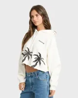 Buzo hoodie Billabong de corte cropped, color blanco, con capucha y cordón ajustable. Cuenta con estampado de palmeras negras en la parte inferior y el logo de la marca bordado en el pecho.