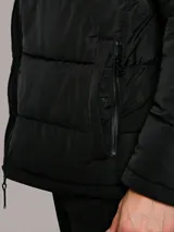 Campera acolchada Calvin Klein de color negro, con diseño matelasseado, cuello alto, cierre frontal con cremallera y bolsillos laterales con cierre. Incluye chaleco interior desmontable.