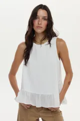 Top blanco de silueta suelta con cuello redondo, sin mangas y con volado asimétrico en el ruedo.