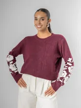 Sweater de tejido de punto color borgoña con escote en V y bordado de flores blancas en las mangas.