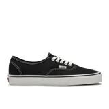 Championes Vans Authentic negros con suela blanca y cordones blancos. Clásicos de caña baja con suela waffle de caucho.