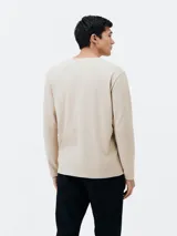 Camiseta de manga larga con escote en V, confeccionada en tejido de algodón, con corte recto y diseño básico.
