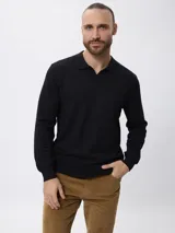 Sweater de punto color negro, con cuello polo y escote en V, de manga larga y diseño ajustado.