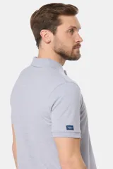 Remera polo azul con cuello en rib y botones personalizados.