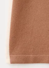 Pantalón tejido de punto color tostado con una franja lateral clara, de corte holgado y pernera ancha.