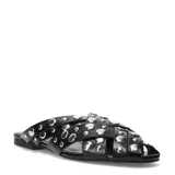 Zuecos planos de mujer Miss Carol Gaira, color negro, con diseño de tiras cruzadas decoradas con tachas metálicas plateadas.