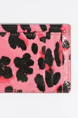 Tarjetero rígido con estampado de leopardo en tonos azul celeste, negro y naranja. Presenta logo metálico de Bimba y Lola en dorado.