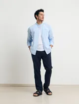Camisa de cuello mao y manga larga, confeccionada en una mezcla de lino y algodón. Presenta un diseño de corte recto con botones en tono natural y un bolsillo pequeño en el pecho.