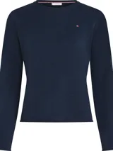 Sweater de punto de lana con cuello redondo, manga larga y corte regular. Presenta un diseño liso en color azul marino con el logo de la marca bordado en el pecho.