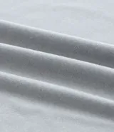 Remera deportiva de hombre con tecnología dry fit, cuello redondo y manga corta. Presenta un diseño liso en color beige con una pequeña etiqueta decorativa en el dobladillo.