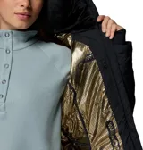 Campera larga Columbia modelo Joy Peak II Mid, color negro, con diseño acolchado y cierre frontal. Cuenta con capucha forrada en vellón, puños con orificios para pulgares y tecnología de aislamiento térmico.